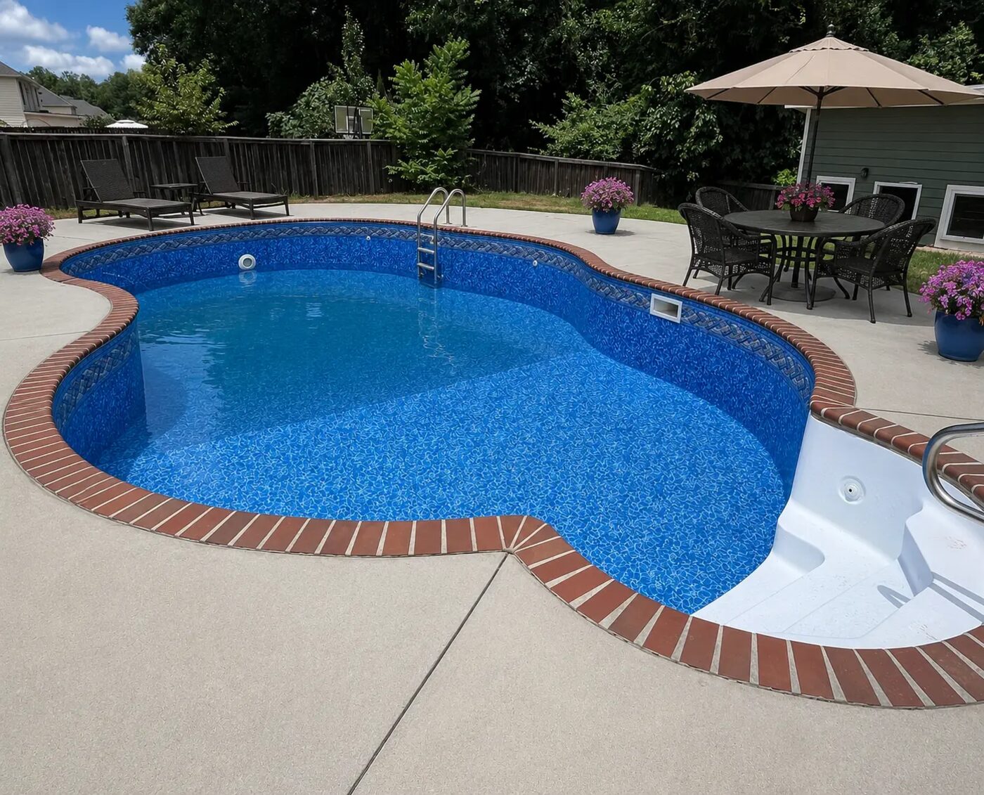 The same freeform pool finished with a new patterned liner and sparkling blue water